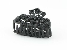 Black metal hair claw clip with black stones on a tiny floral pattern