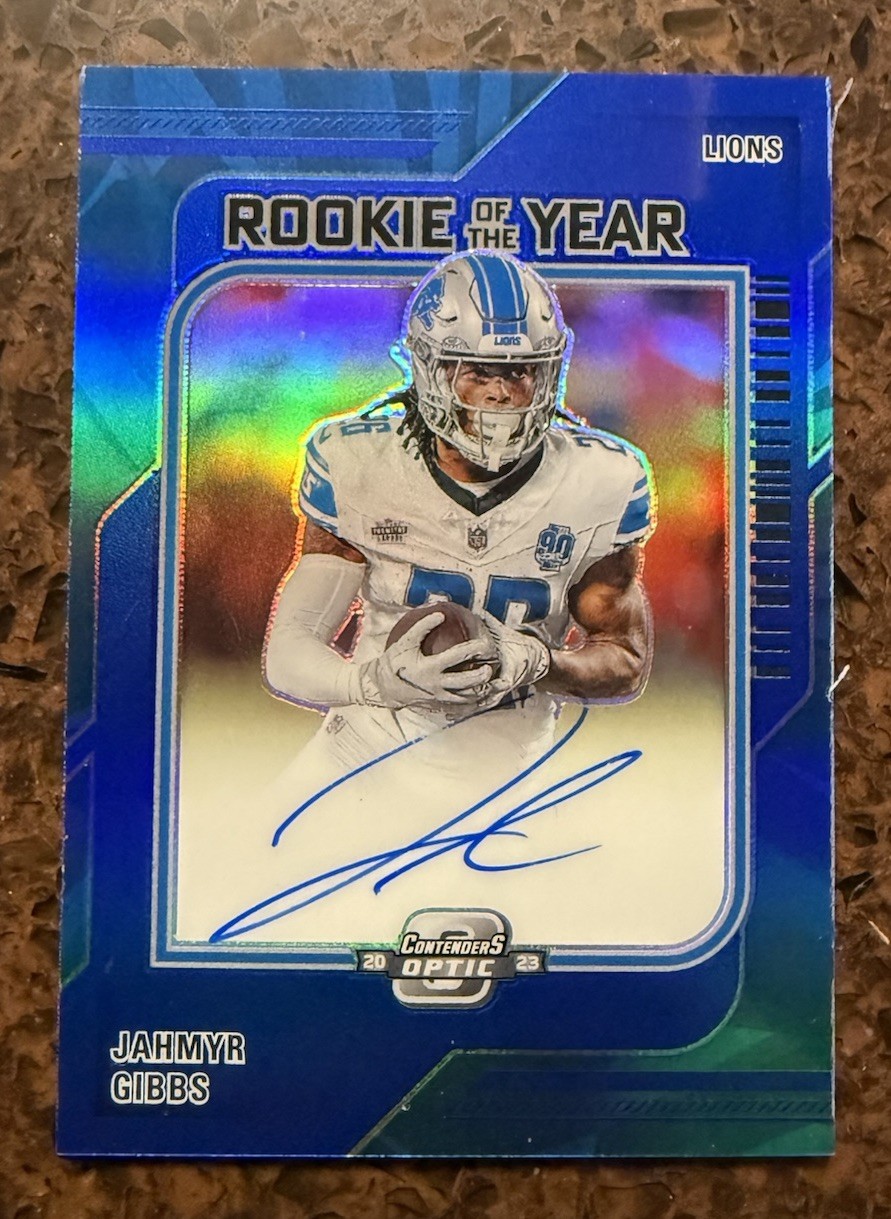 2023 Contenders Optic - Jahmyr Gibbs Rookie Of The Year Auto /45 Blue Lions RC