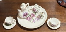 Vintage 10-piece miniature porcelain collectible tea set.