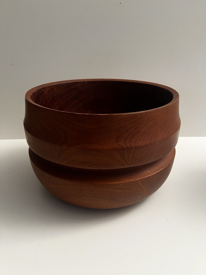 At 12x8 inches, this carved solid teak bowl commands a room — a true statement centerpiece with satisfying heft and organic warmth.