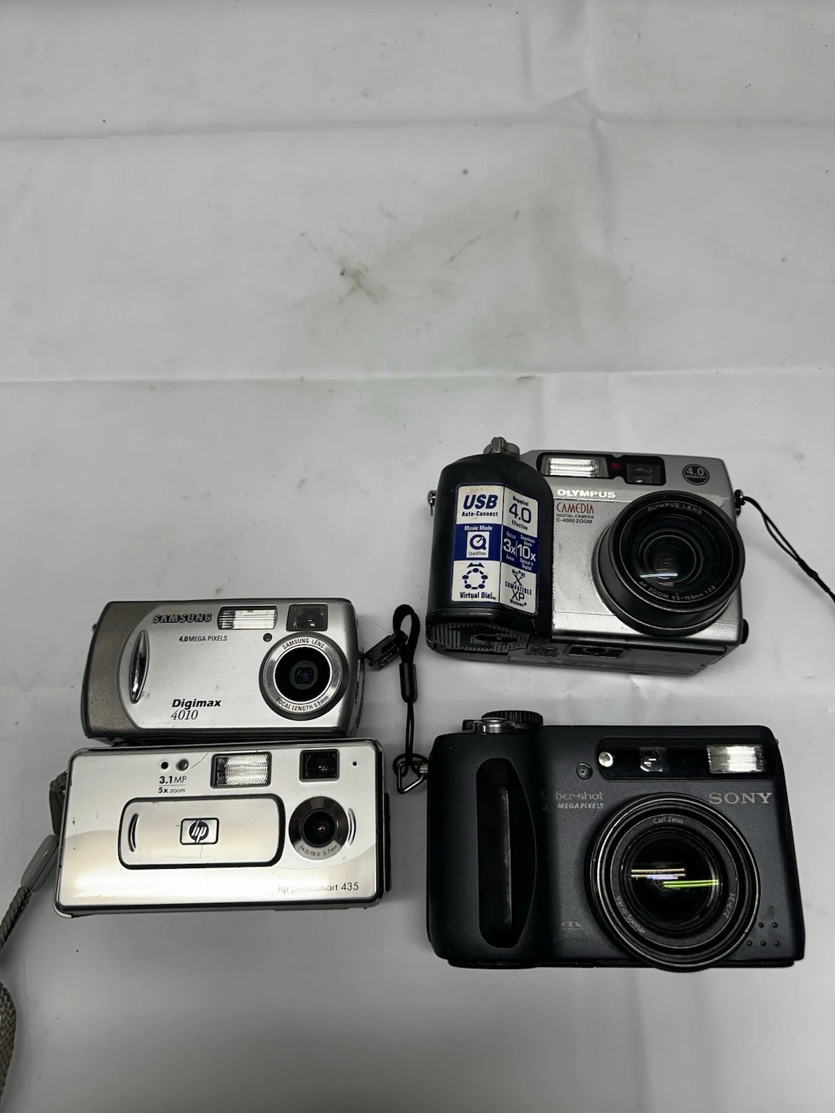 Lot of 4 Digital Cameras, One Works Other 3 Unknown. Samsung, Sony, Olympus, Hp