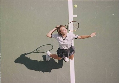 Martina Hingis of Switzerland focuses ball as she tosses it up for- Old Photo