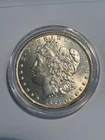 1884 $1 Morgan Silver Dollar in coin capsule uncirculated New Orleans Mint