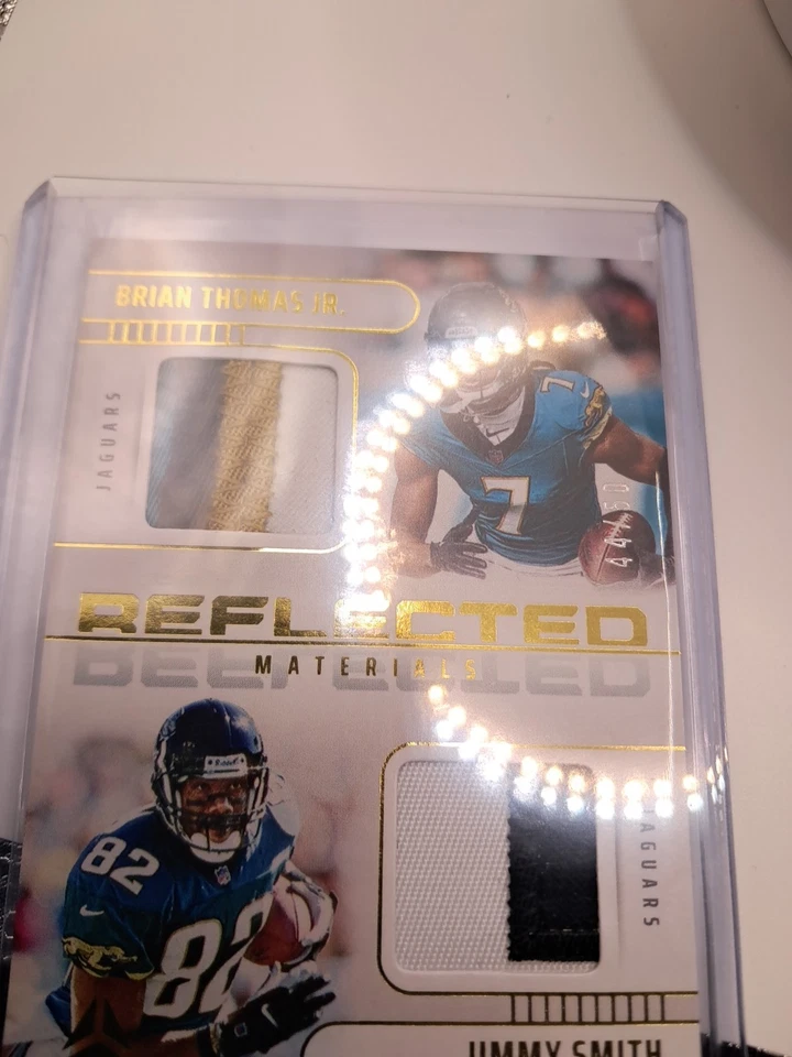 2025 Luminancia Reflejada Materiales Oro 44/50 Brian Thomas Jr & Jimmy Smith Foto 2 de 4