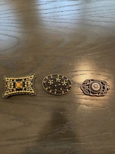 set of three metal and jeweled belt buckles on missing moving part