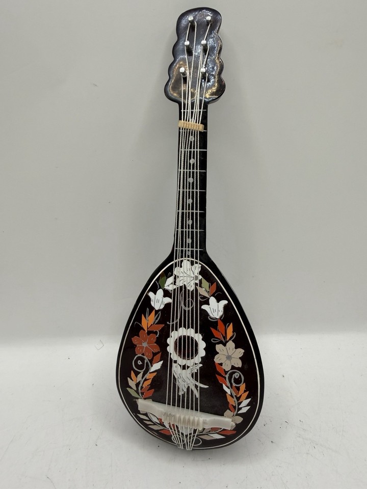 A working antique Italian mandolin-shaped music box — the instrument form factor makes it a charming conversation piece, not just a box that plays a tune.