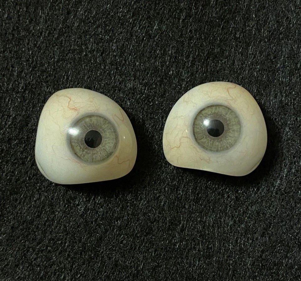 A matched set of vintage prosthetic eyes — real medical artifacts that straddle the line between unsettling curiosity and legitimate oddities collecting.