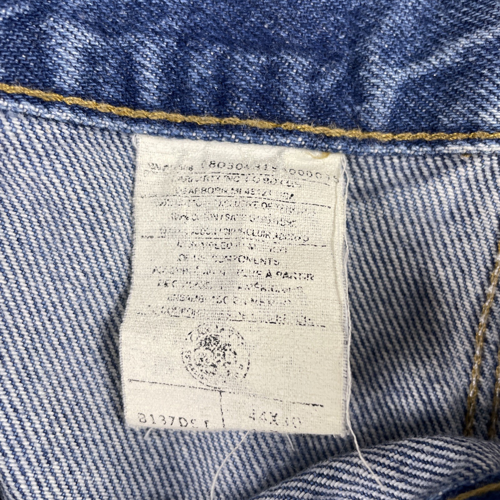Yellow-edged Y2K Carhartt men’s 44x30 denim with faded thighs, pockets, and white size tag on waistband.