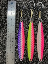 Dimple surface 8oz Diamond jig. Glow finish. Rigged w/400lb aramid assist hooks.