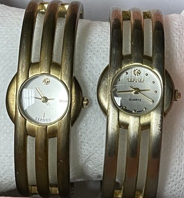 This is a pair of gold-tone women's bangle watches