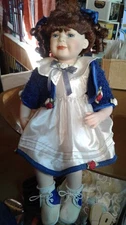 Porcelain Doll   / 10 ins setting 10 ins. legs Brunette Pig tails