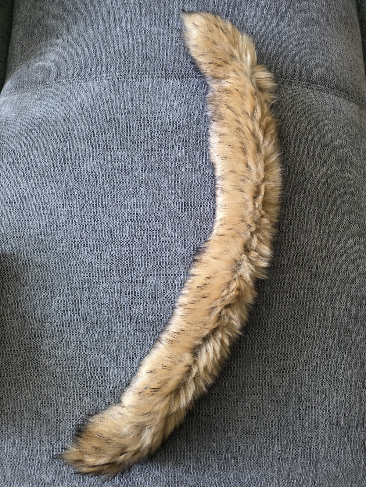 Tan faux fur collar stole with red lining and loop fastener.