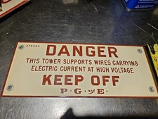 Danger keep off PG&E sign tower supports high voltage wires
