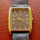 Vintage Timex Tank-Style Quartz Watch with Gold-Tone Case & Black Strap Read