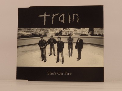 TRAIN SHES ON FIRE (F87) 4 Track CD Single including Picture Sleeve COLUMBIA