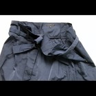 Navy blue paperbag waist skirt with matching fabric belt, side buckle detail, and “THEORY” label on waistband.