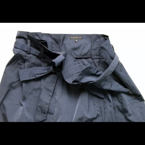 Navy blue paperbag waist skirt with matching fabric belt, side buckle detail, and “THEORY” label on waistband.