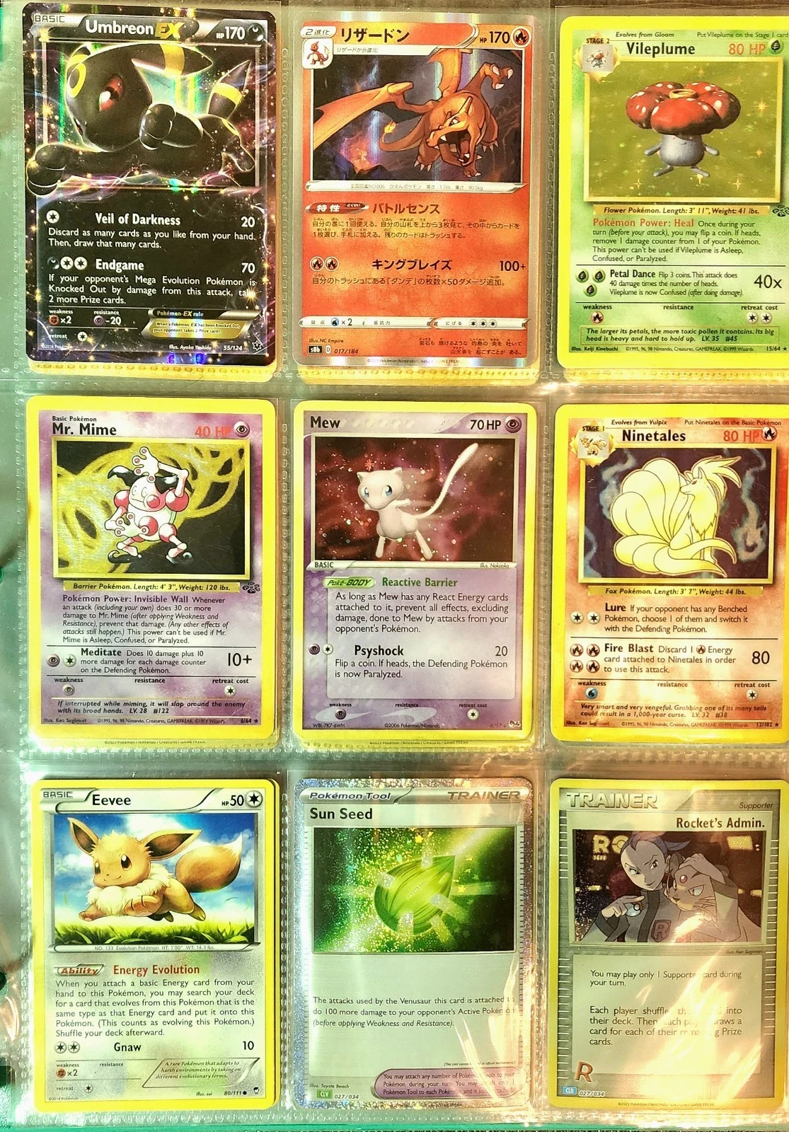 A binder page of sleeved Pokemon cards