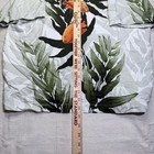 Vintage white Wyland AFTCO Bluewater men’s Hawaiian shirt with orange fish rayon and green leaf pattern, shown beside a wooden ruler.