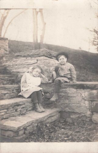 Little Boy in Knickers & Girl in Pigtails Sit on Steps Photo Postcard 1910s-20s - Picture 1 of 2