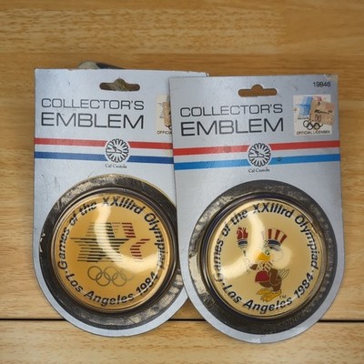 2 1984 Olympics XXIII Los Angeles Collectors Car Badge Emblem NIP Cal Customs A1