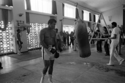 Muhammad Ali hitting heavy bag while training before fight v - 1974 Old Photo