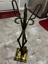 This item is a vintage brass fireplace tool set, typically featuring tools