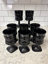 Set of 8 Noritake Spotlight black glass goblets with textured thumbprint design.