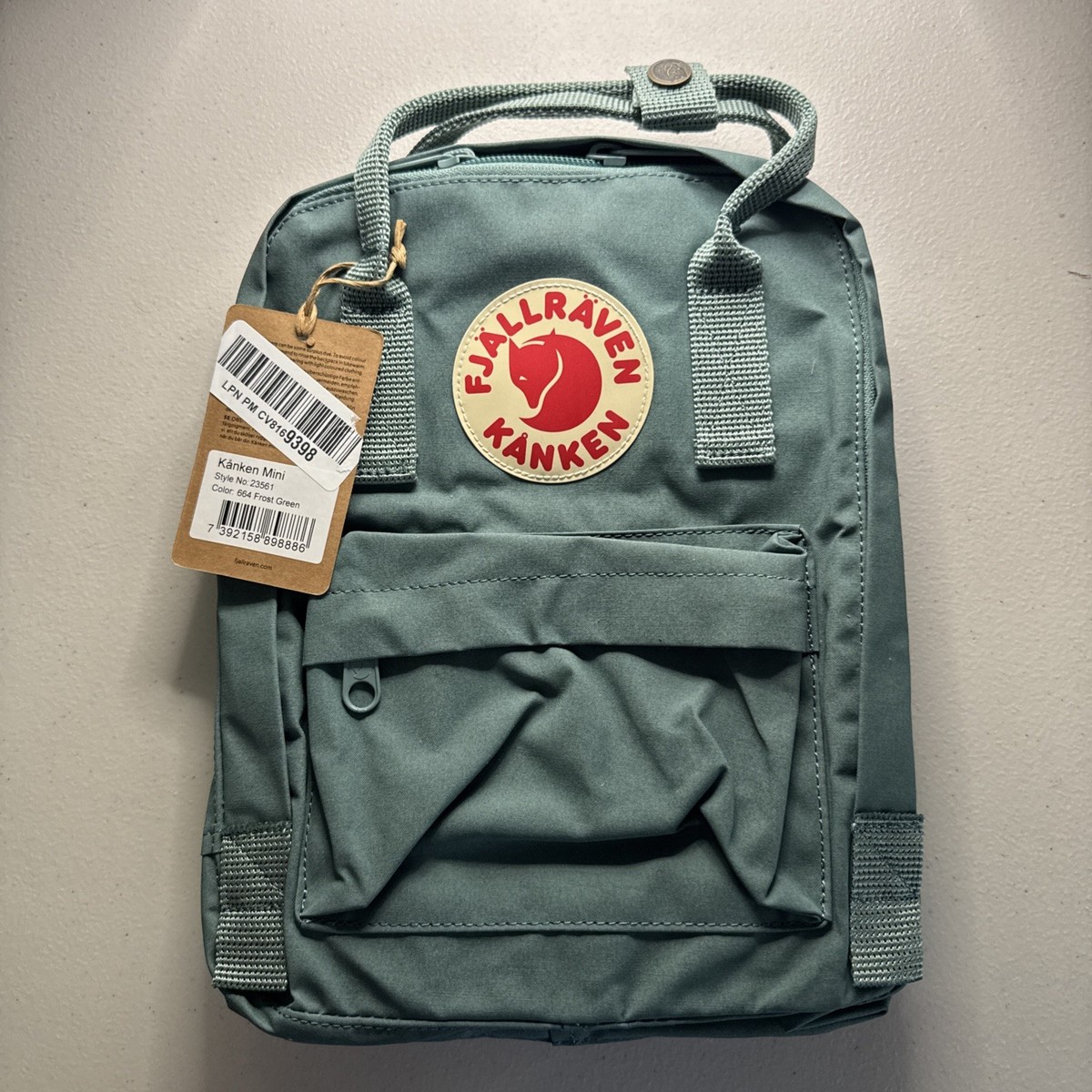 fjallraven kanken mini backpack ocean green F23561-645 Sportique Kanken backpack in little format with long shoulder straps that can be adjusted to fit both children and adults Ocean Green Mini Backpack Fjallraven