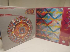 Two UNOPENED 500 piece American Publishing puzzles: Aztec Cosmos; Fabrication.