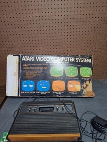 Atari 2600 Video Game Console With 2 Controllers,  Catalog & Damaged Box