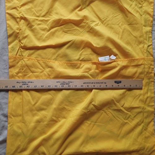 Yellow fabric Golden State Warriors NBA pillow case with 19 x 25 dimensions, shown with a wooden ruler for scale.