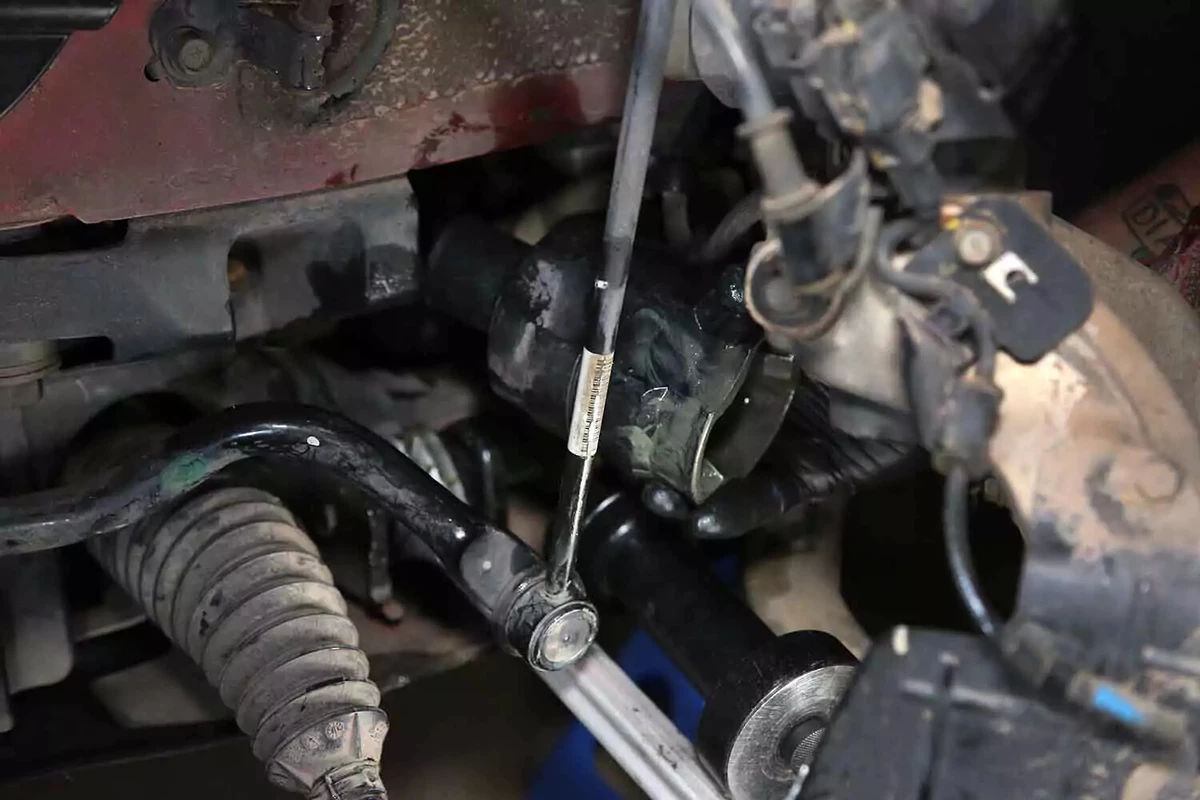 With the joint separated, a mechanic slides the stub axle out of the vehicle.