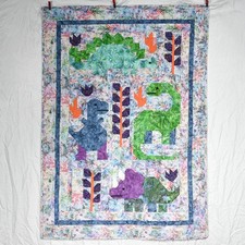 New handmade child's quilt of happy dinosaurs, approx 38" x 53"