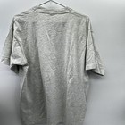 Gray vintage John Jay baseball T-shirt with short sleeves, shown from the back on a hanger against a white wall.