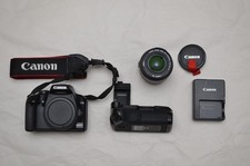 Canon EOS 1000D DSLR + 18-55mm lens + battery grip + charger + cables + manual