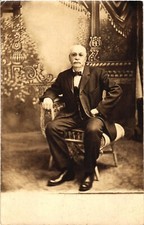 An Old Photograph of a Man in Suit Sitting Postcard