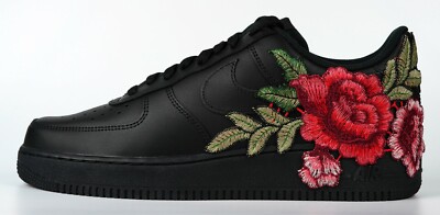 black nike shoes with flowers