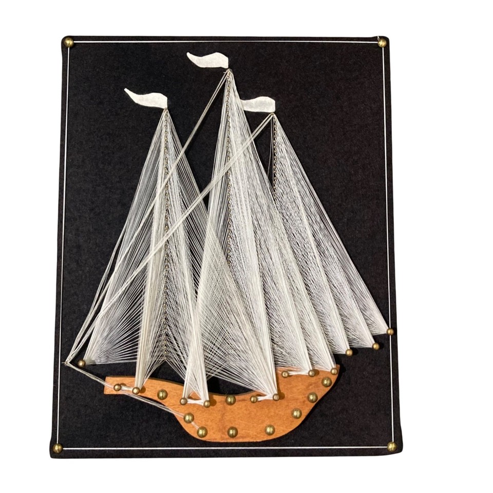 Vintage string art of a sailing schooner — a genuinely nostalgic, tactile, and visually striking piece of folk-craft wall art that nobody makes anymore.