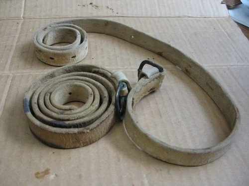 Interesting pair of original US? saddle white buff leather coat straps.