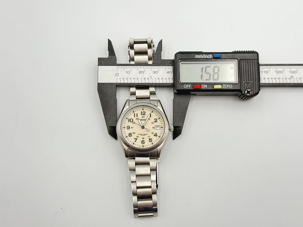 SEIKO 7N42-8260 SBCA003 Quartz Field Watch Cream Dial Arabic Date