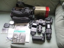 Canon A-1 fotocamera reflex pellicola 35 mm, 2 obiettivi, azionamento motore, flashgun, borsa a tracolla, ottime condizioni