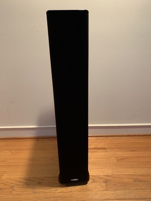 tower speakers on hardwood floor