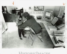 1995 Press Photo Terry Reed helping her child get dressed for outdoors, Alaska