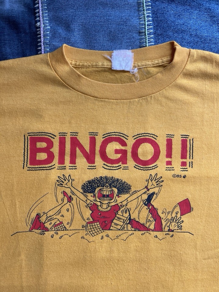 A USA-made 1985 Bingo novelty tee that's legitimately rare — the kind of hyper-niche vintage graphic tee that vintage heads actively hunt for.