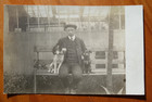 Jack Russell terrier and a puppy sit on bench with nattily dressed man postcard — photo 1