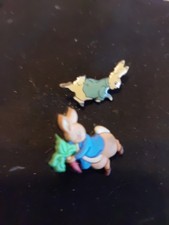 B/pin badges feature the Beatrix Potter character Peter Rabbit,