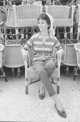 Italian actress Giorgia Moll sitting wicker chair smiling during 1- Old Photo 1