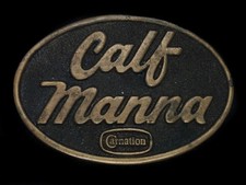 TB11164 VINTAGE 1977  CARNATION CALF-MANNA  ADVERTISEMENT BELT BUCKLE