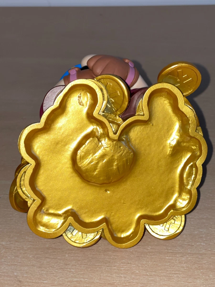 Figura Mario Bros sentada sobre Monedas Nintendo